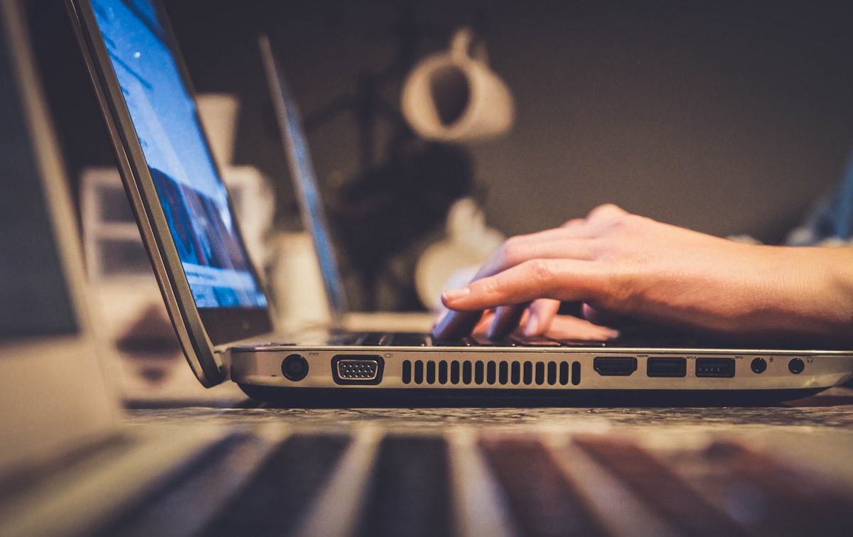 Professional working on a laptop reviewing secure document sharing and email attachment risk